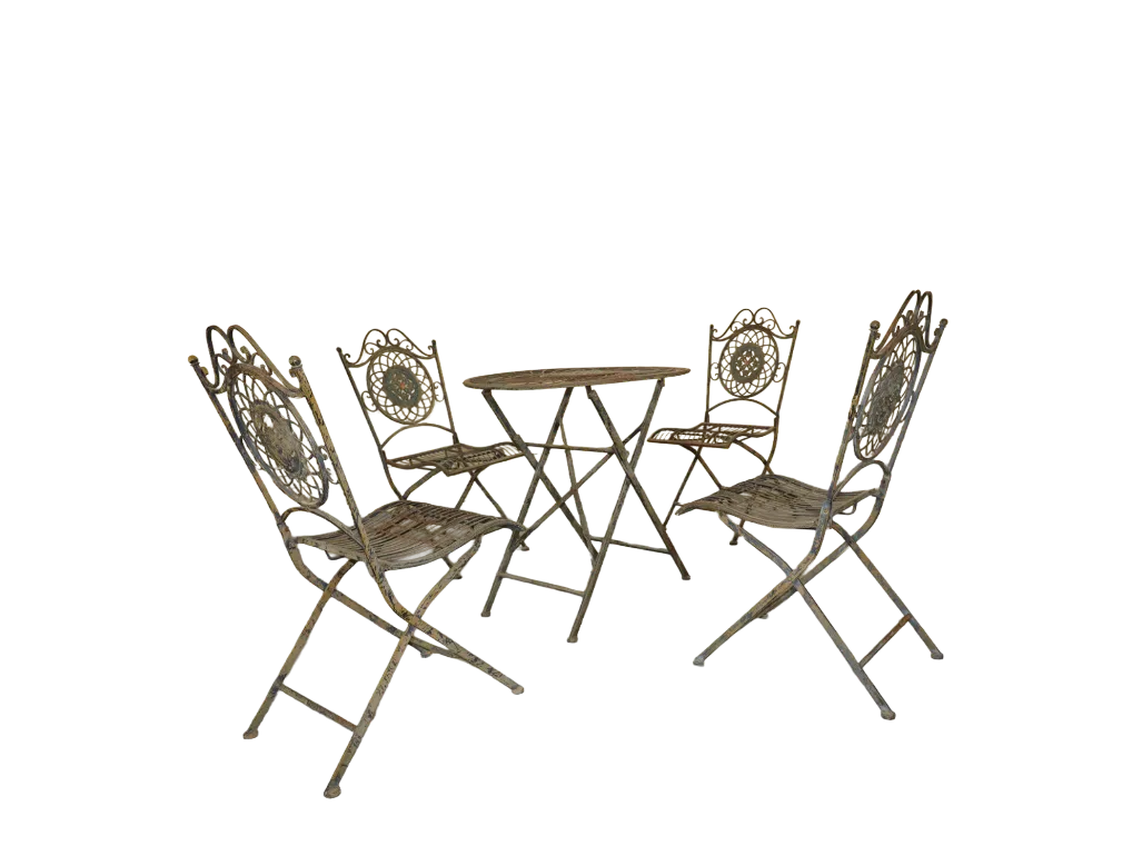 Four folding wrought iron garden chairs with circular floral medallion backs surrounding a matching round table.